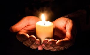candle held in mcupped hands